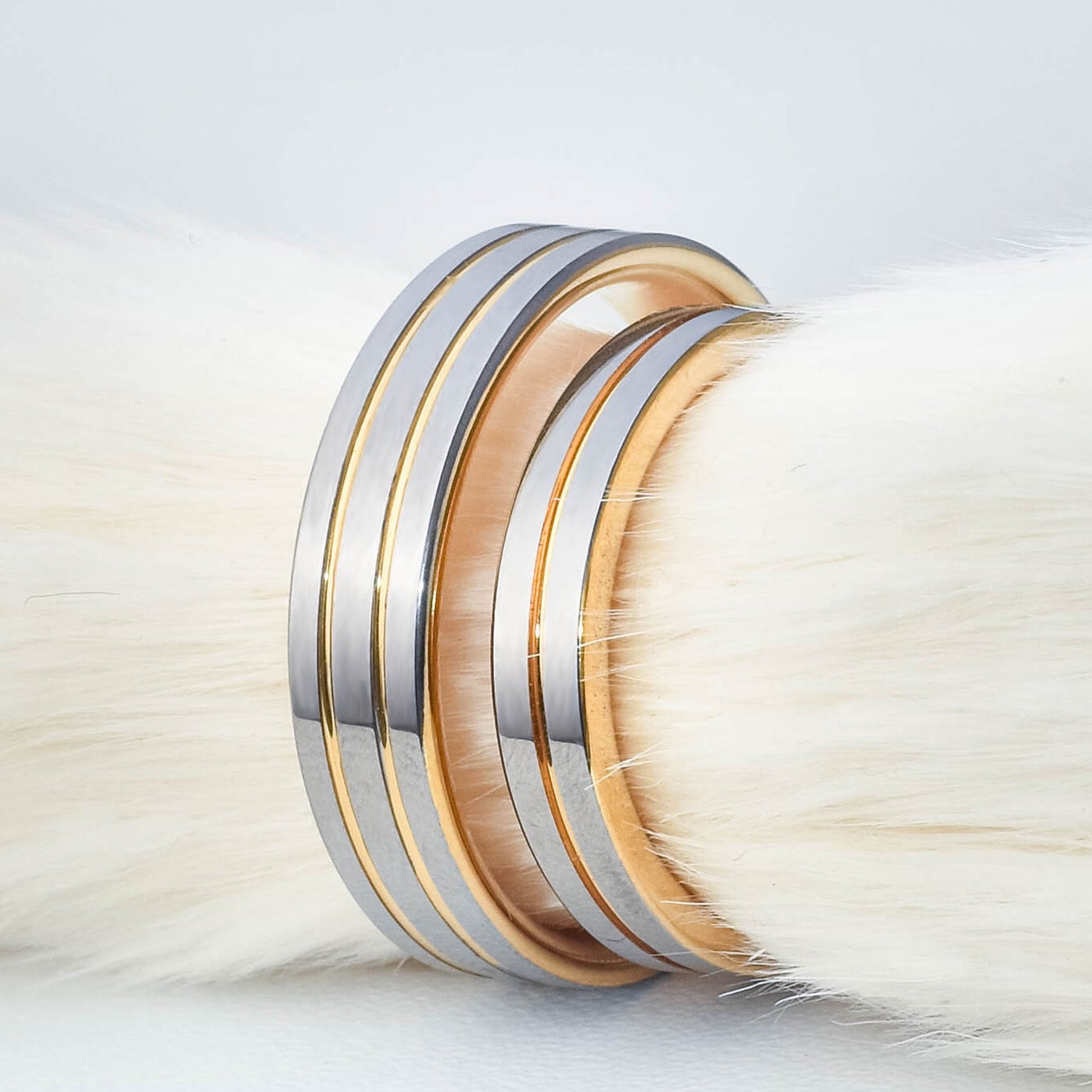 Anillos de matrimonio de tungsteno para parejas con diseño de tres franjas plateadas y canales laminados en oro dorado sobre fondo blanco - Código 9092