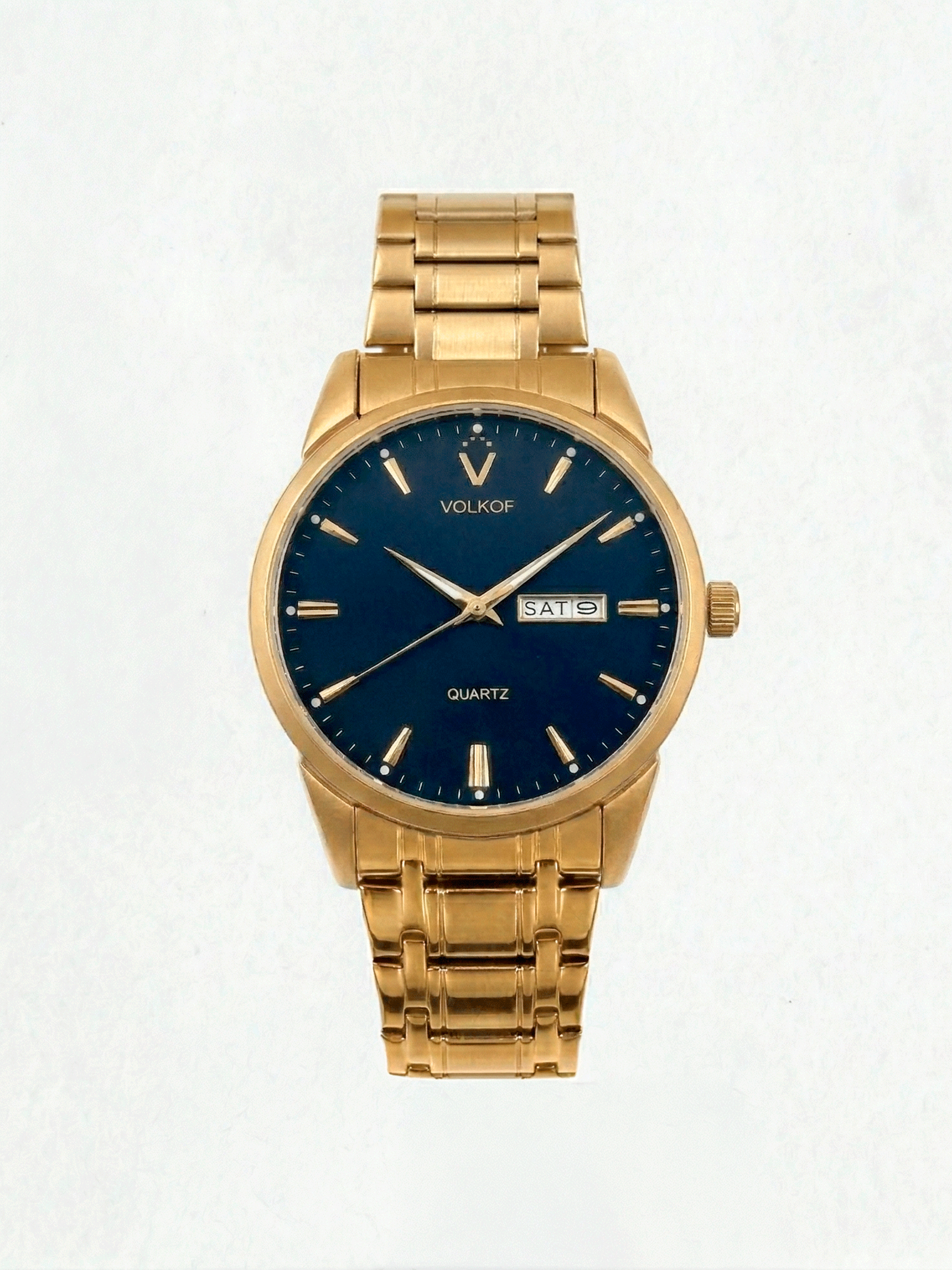 Reloj analógico para hombre en acero inoxidable color oro, esfera azul oscuro mate con índices lineales dorados, doble ventana de fecha y día, y brazalete de eslabones dorados