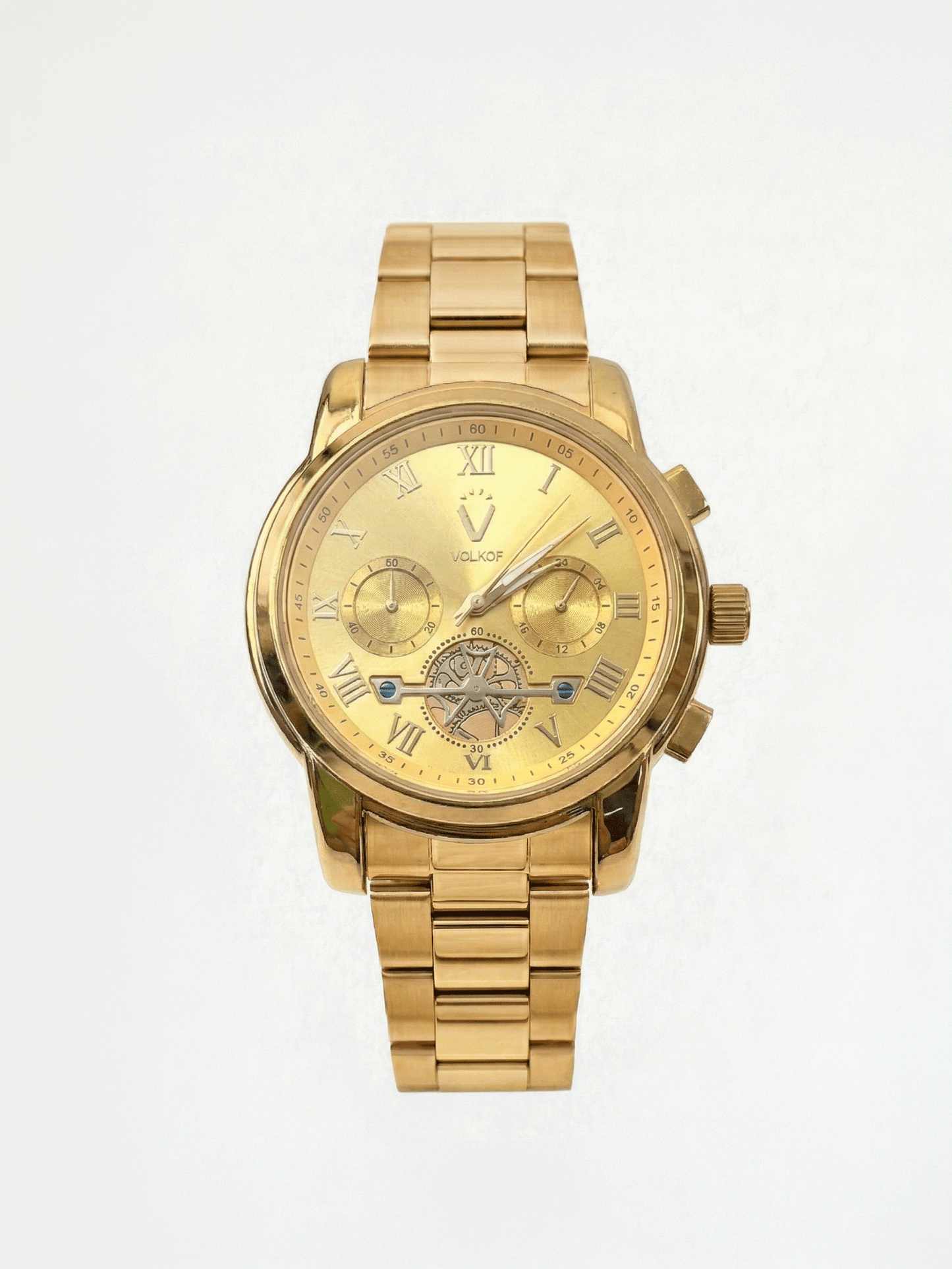 Reloj analógico para hombre totalmente dorado en acero inoxidable, esfera con números romanos, dos subesferas funcionales, detalle de maquinaria visible a las 6 en punto y caja de 42mm