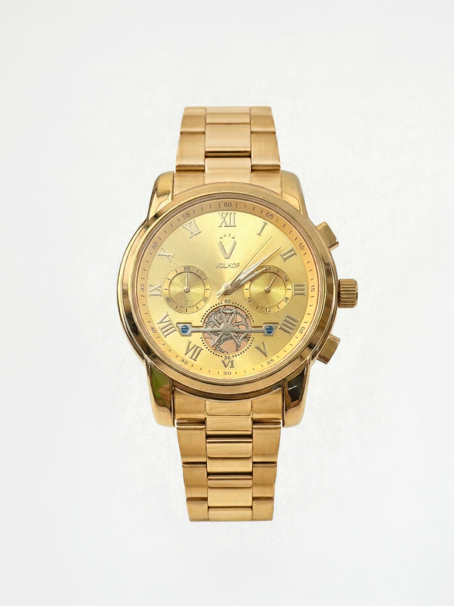 Reloj analógico para hombre totalmente dorado en acero inoxidable, esfera con números romanos, dos subesferas funcionales, detalle de maquinaria visible a las 6 en punto y caja de 42mm